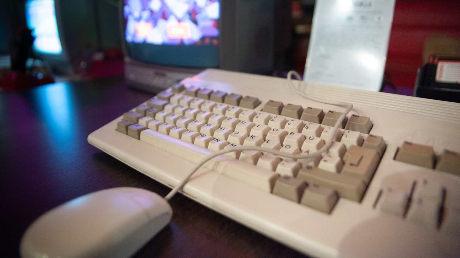 Alte Computertastatur mit Maus, verbunden mit einem Monitor.