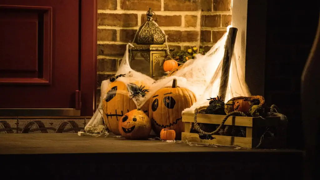 Halloween-Dekoration an einer Türschwelle mit geschnitzten Kürbissen