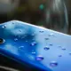Wassertropfen auf der Rückseite eines blauen Smartphones
